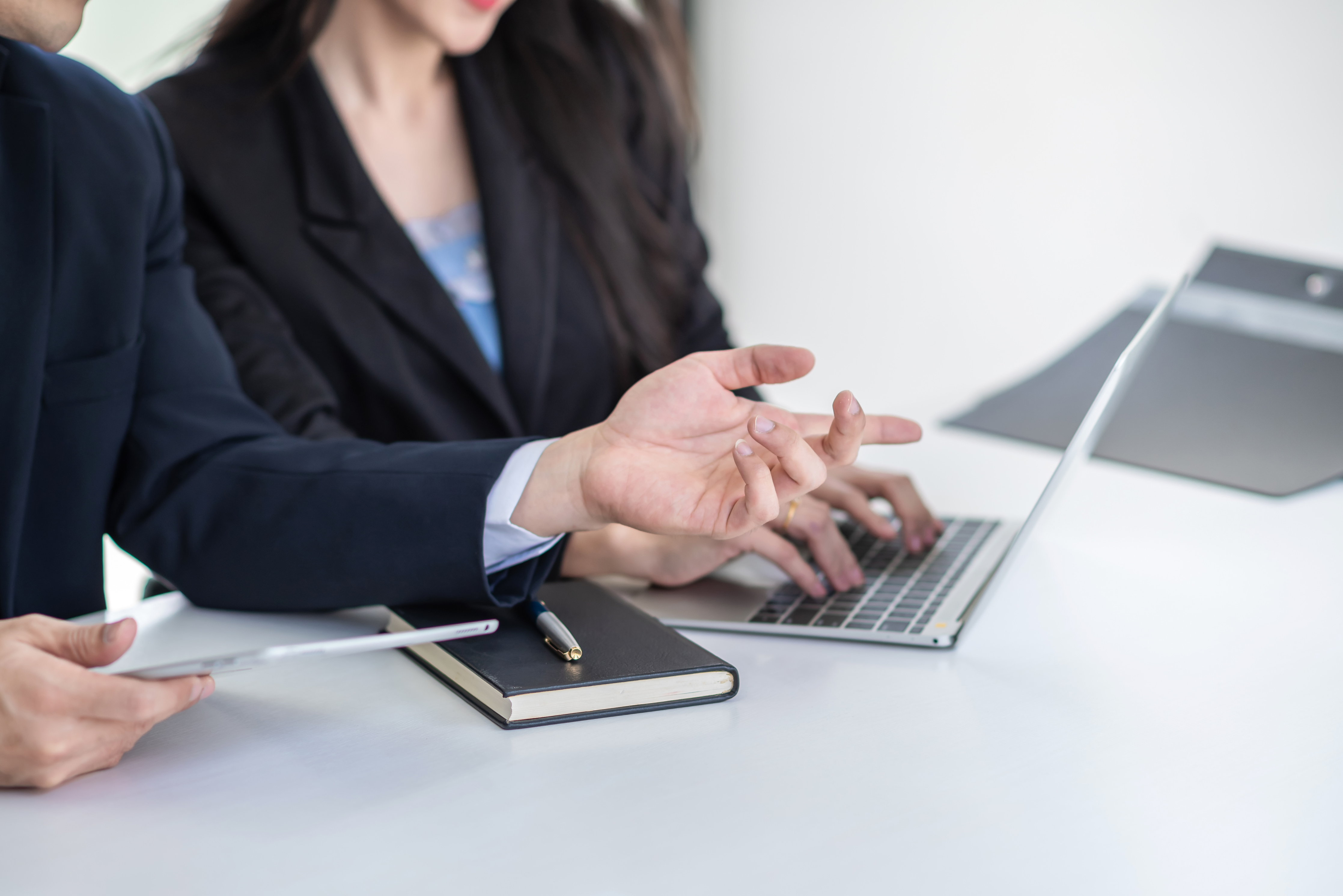Businessman and Businesswoman Working in the Office Using a Digi